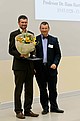 Dr. Ludger Hermann receiving the prize on behalf of prize winner of Willmar Leiser , from Dr. Andrea Fadani, director of the Foundation fiat panis